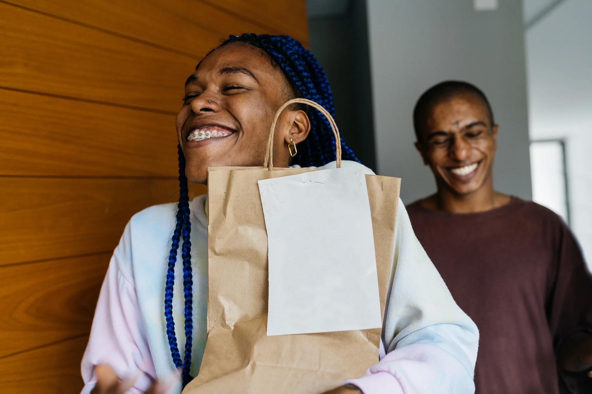 A smiling customer carrying shopping bags